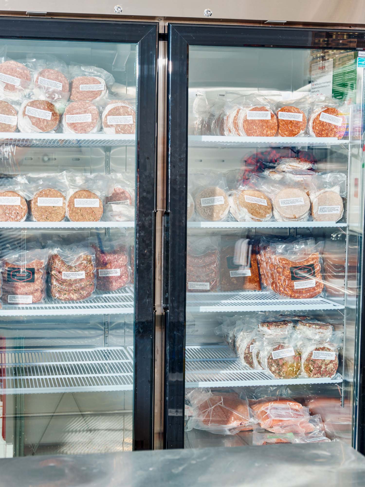 A freezer full of house-made burgers and sausages